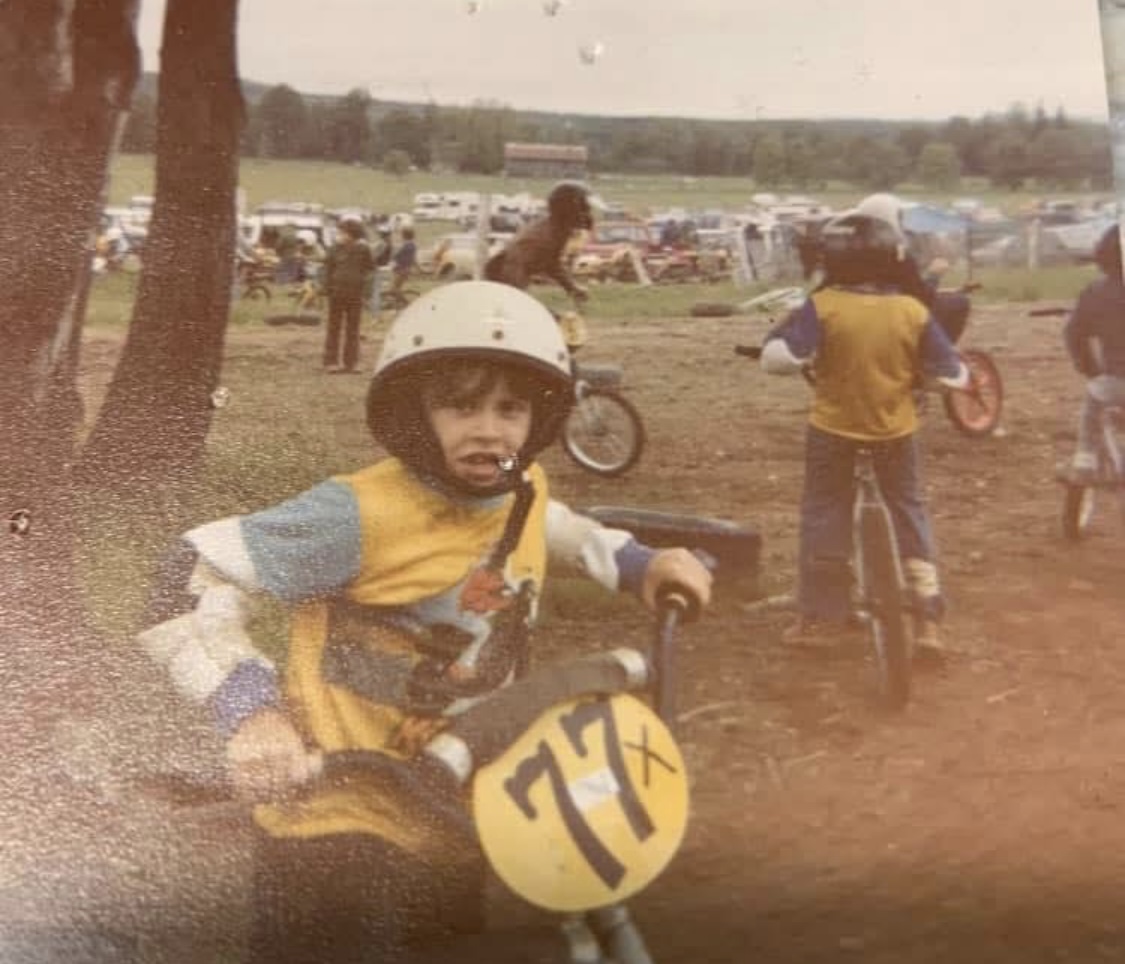 David as a young BMX racer at the starting line, number 77